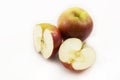 Two half apples and whole apple sliced Ã¢â¬â¹Ã¢â¬â¹on a white background